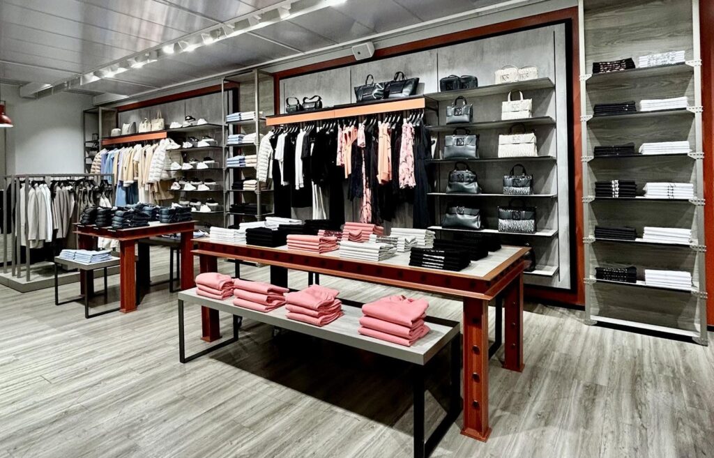 Store floor with red-trimmed tables and wall fixtures